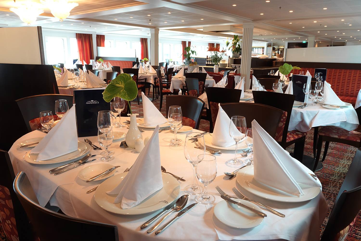 Main dining room aboard AmaDolce with elegant table settings