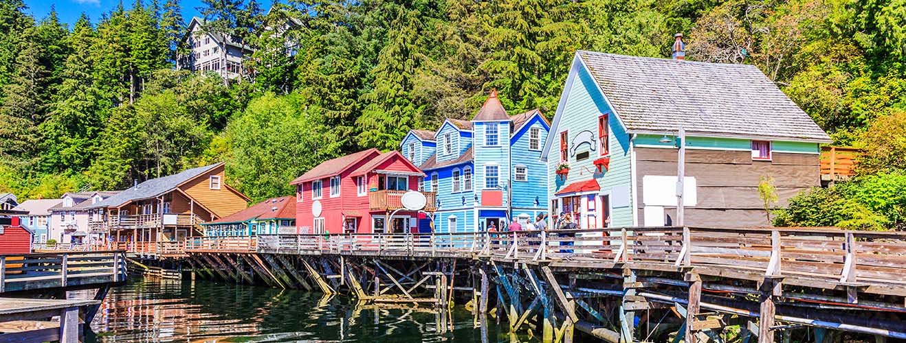 Jetty lined with houses surrounded by forest